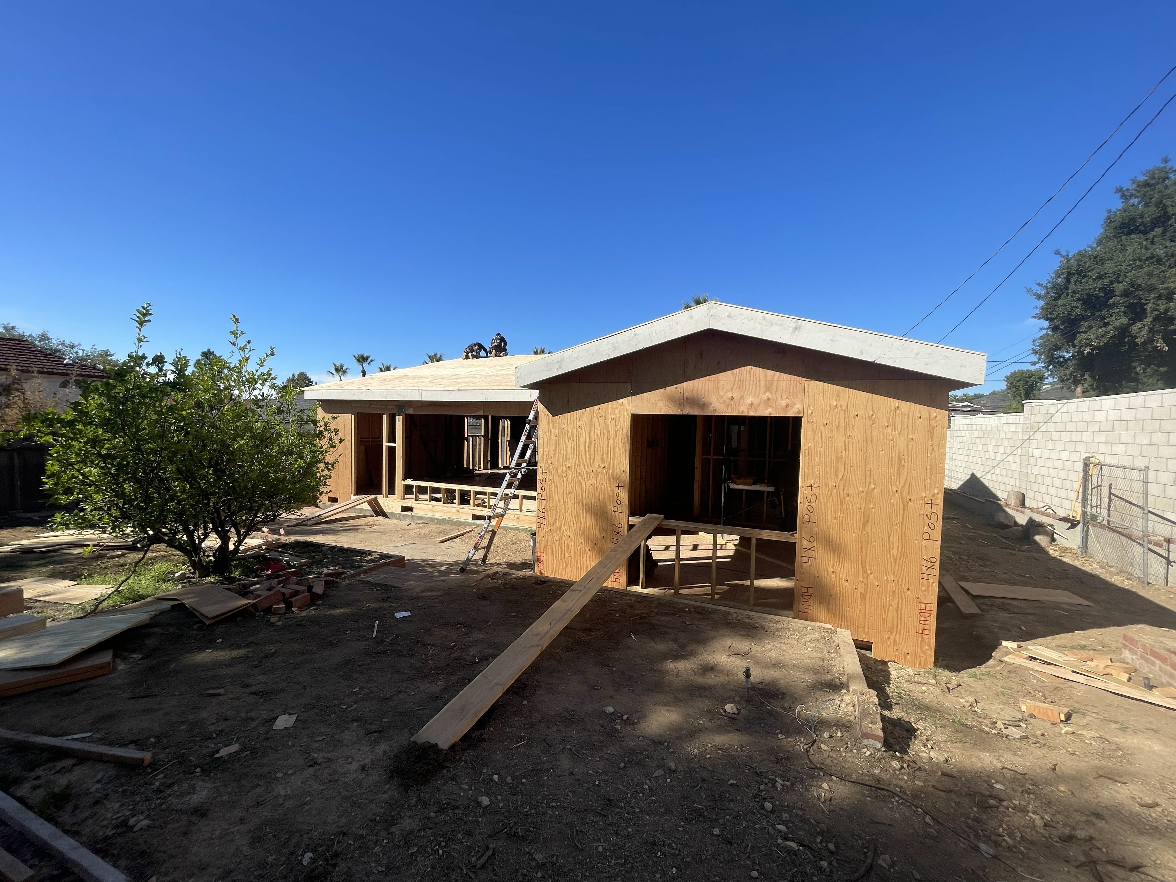 New home wood framing with flat roof plywood sheathing in progress in Los Angeles